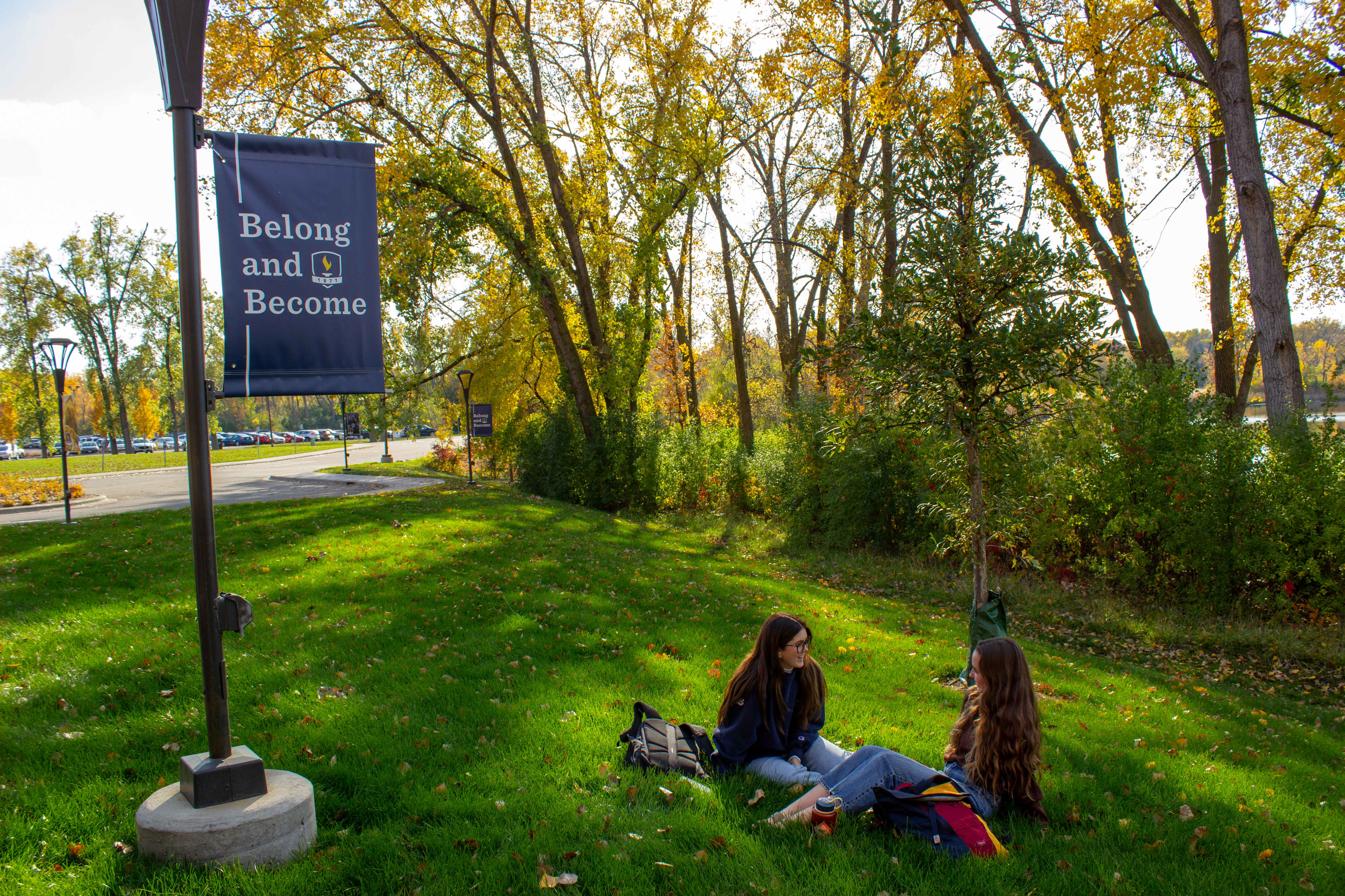 Students add toppings to ice cream at a campus event with a sundae bar.
